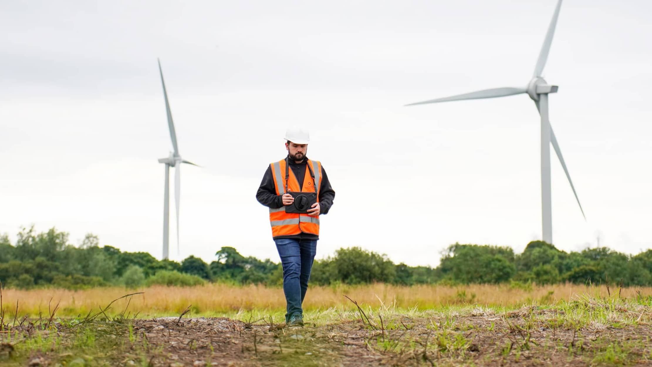 Survey in field with wind turbine behind